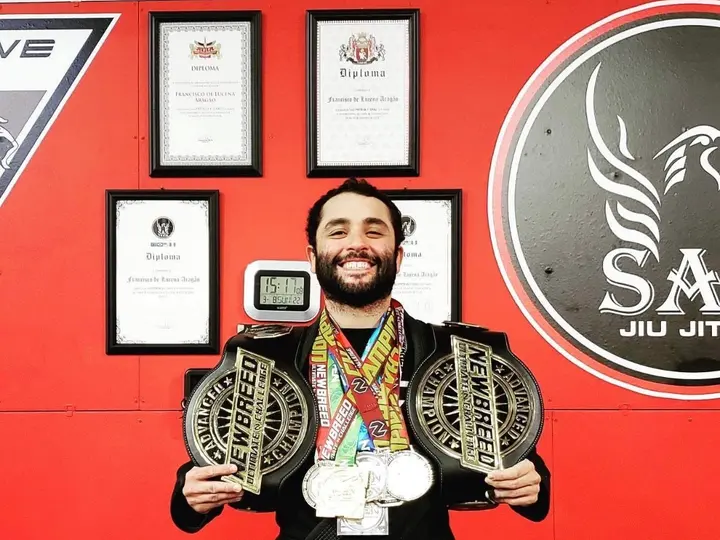 Brazilian Jiu Jitsu instructor with championship belts and medals at Competitive Edge Florence SC